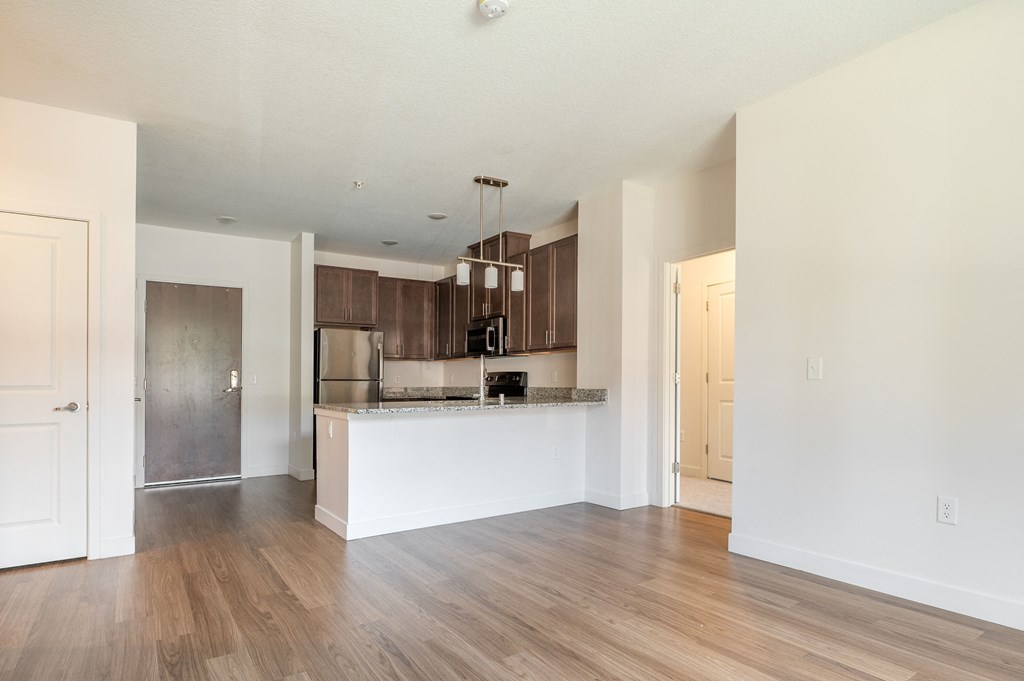 a kitchen and living room with hardwood floors and white walls at Sonder House, Brooklyn Center, MN, 55430