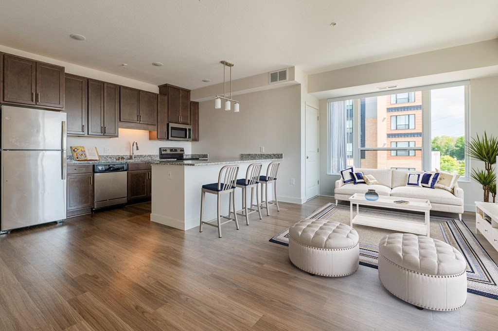 a living room and kitchen with wood flooring and a large window at Sonder House, Brooklyn Center, MN
