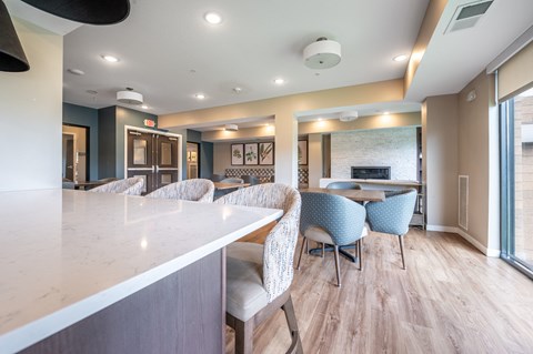 a resident clubhouse with a kitchen and dining area at Sonder Point 50+ Apartments, Brooklyn Center, MN