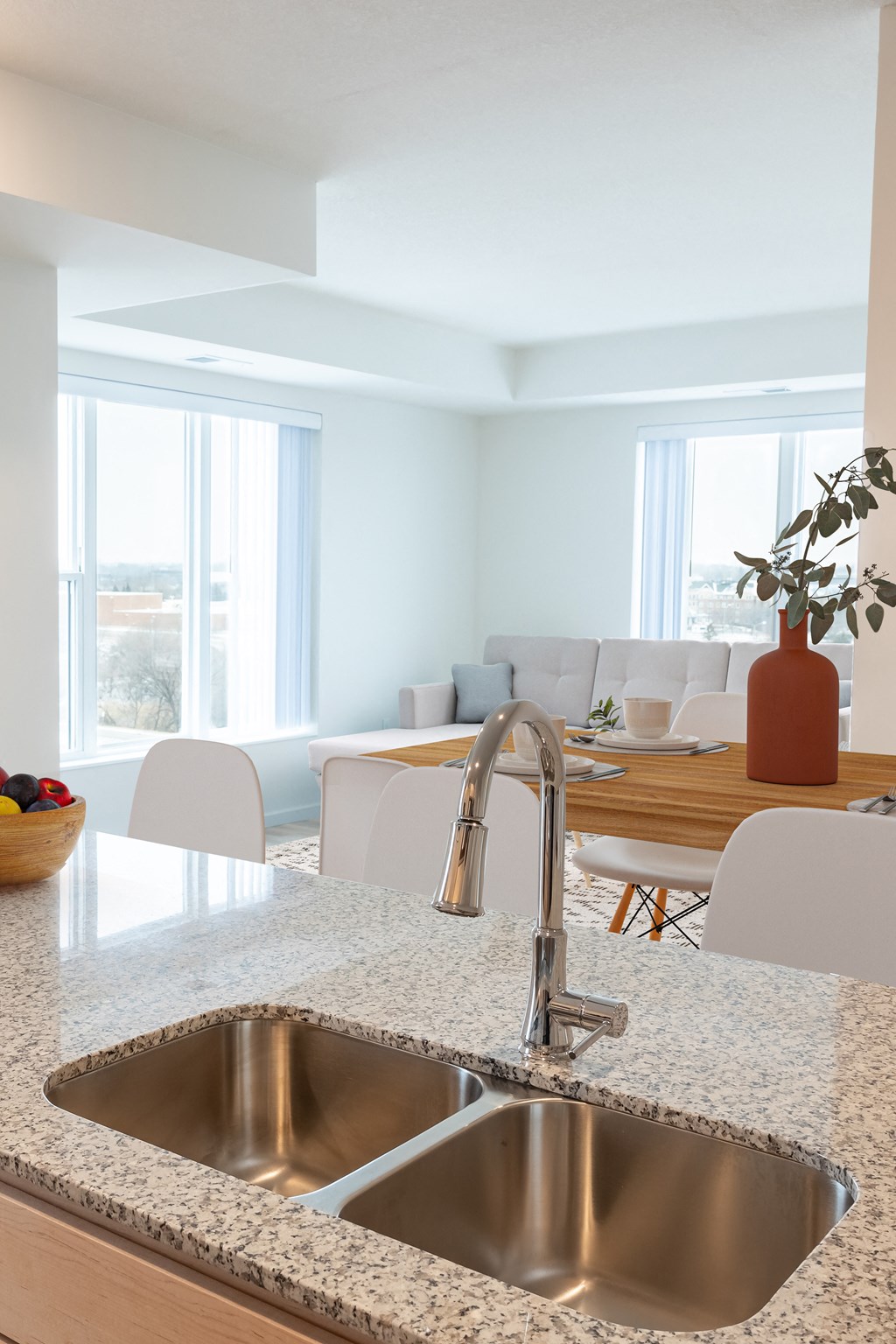 a kitchen with a sink and a table with chairs