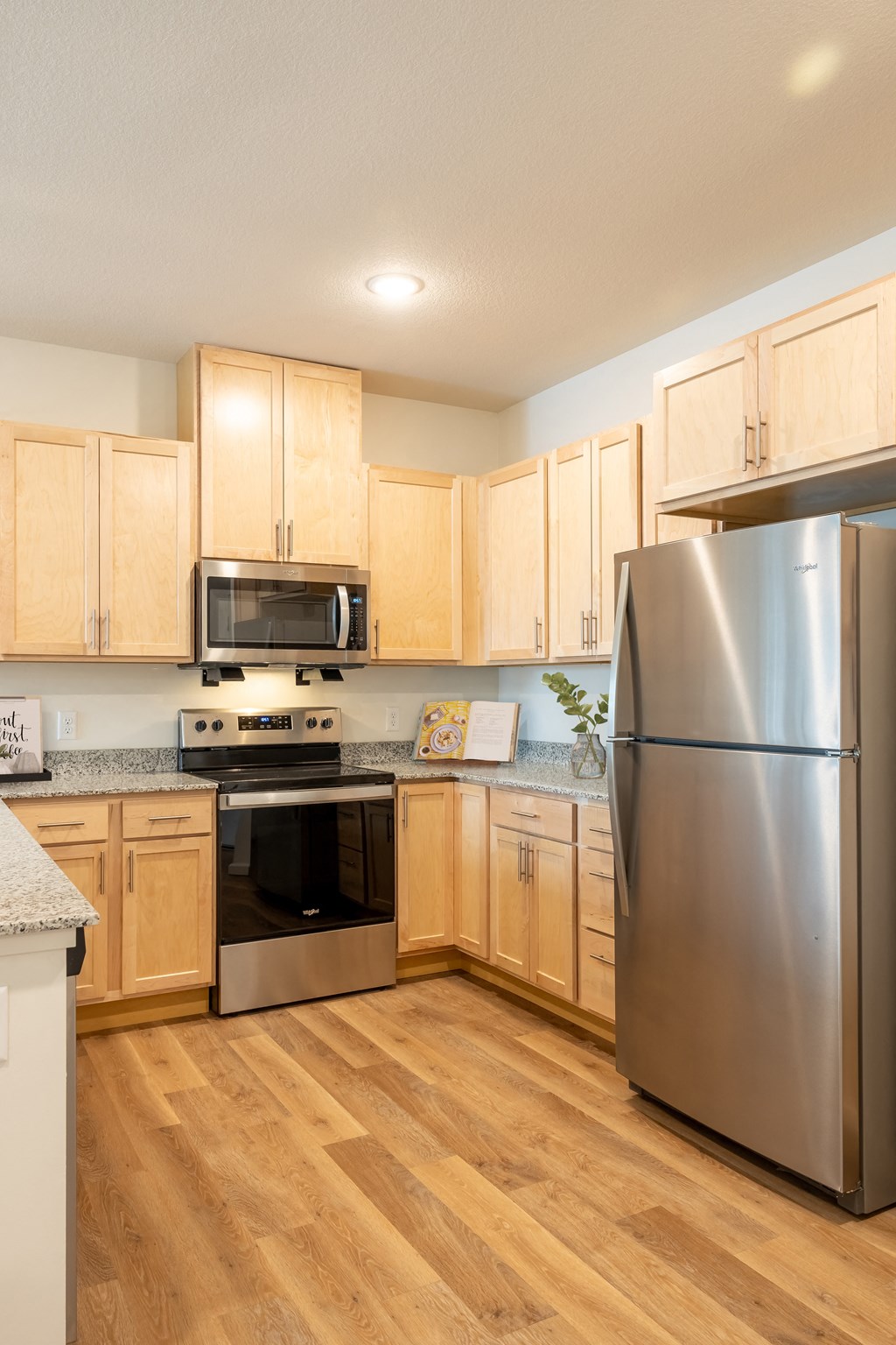 a kitchen with stainless steel appliances and wooden cabinets