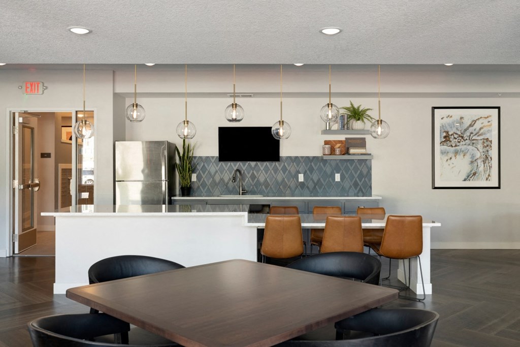 a kitchen and dining room with a table and chairs