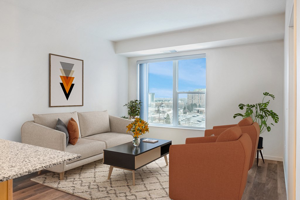 a living room with a couch and a table and a window