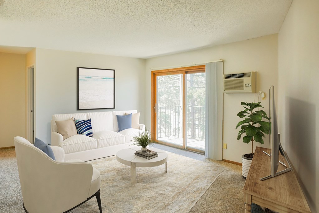 a living room with a white couch and a sliding glass door