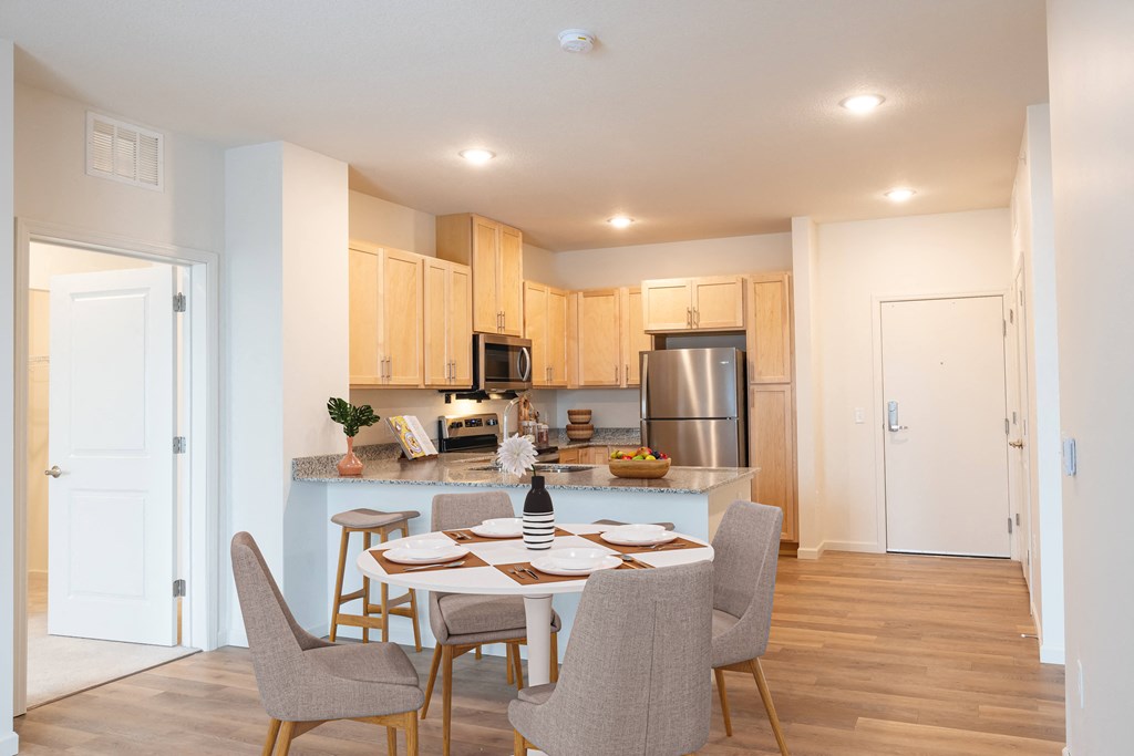 an open kitchen and dining room with a table and chairs