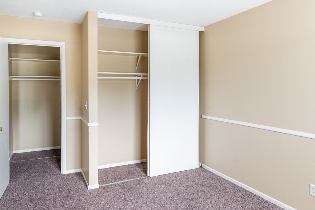 a bedroom with a wardrobe and a carpeted floor