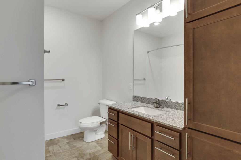 a bathroom with a toilet and a sink and a mirror
