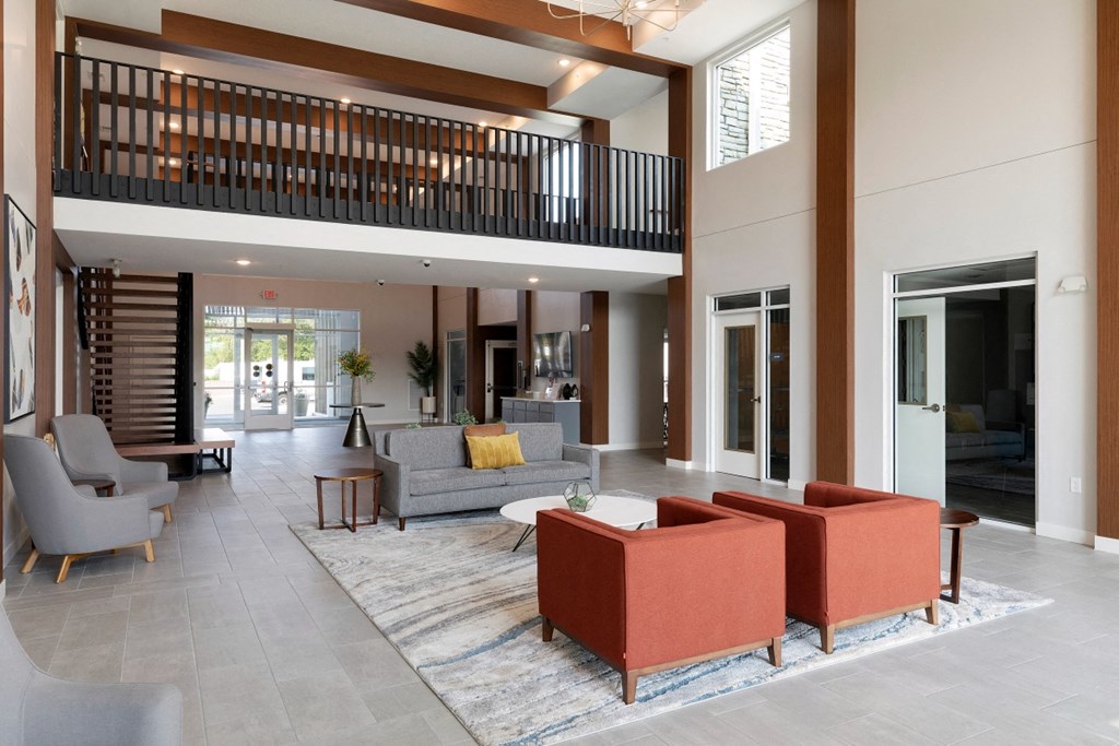 a living room with couches and chairs and a large rug