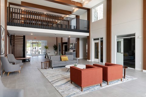 a living room with couches and chairs and a large rug