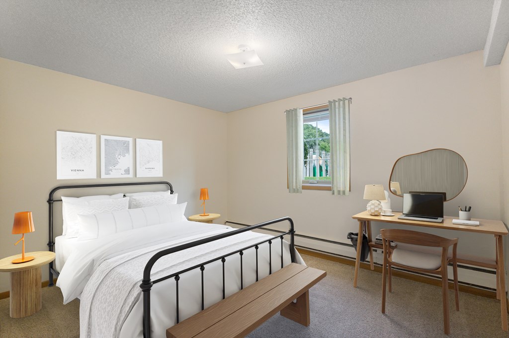 A bedroom with a bed, desk, chair, and window.