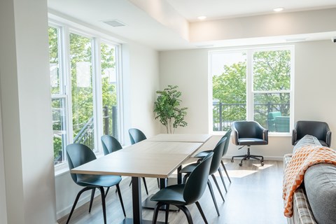 A conference room with a long table and chairs.