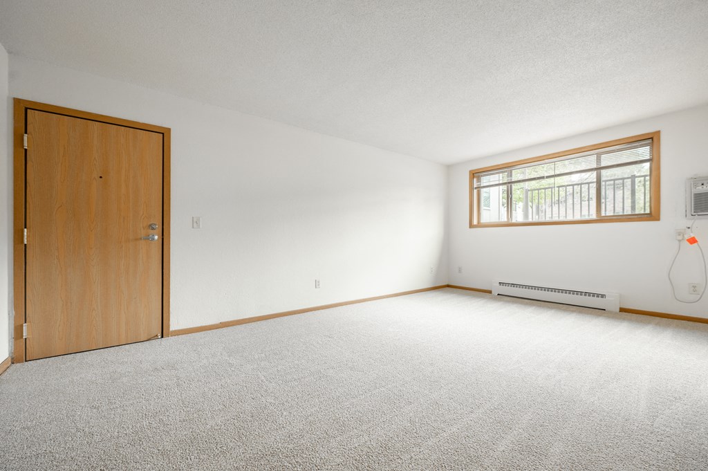 a bedroom with a door and a window