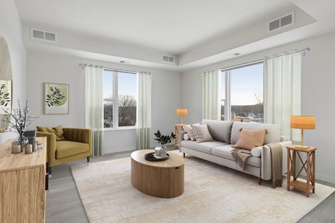 A living room with a yellow chair and a white couch.