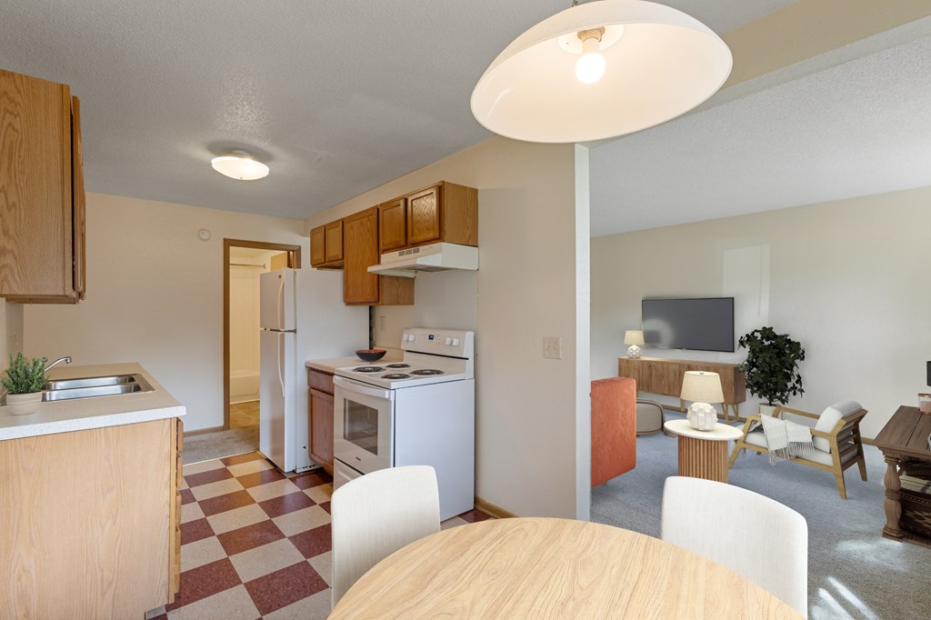 A kitchen with a checkered floor and a dining table with chairs.