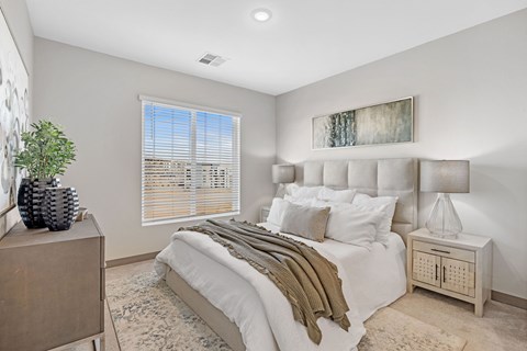 A bedroom with a large bed and a wooden dresser at Copa Flats Apartments, Maricopa, 85138