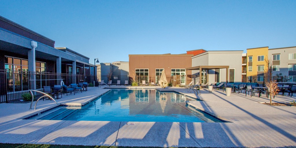 a swimming pool with a building in the background at Copa Flats, Maricopa, Arizona
