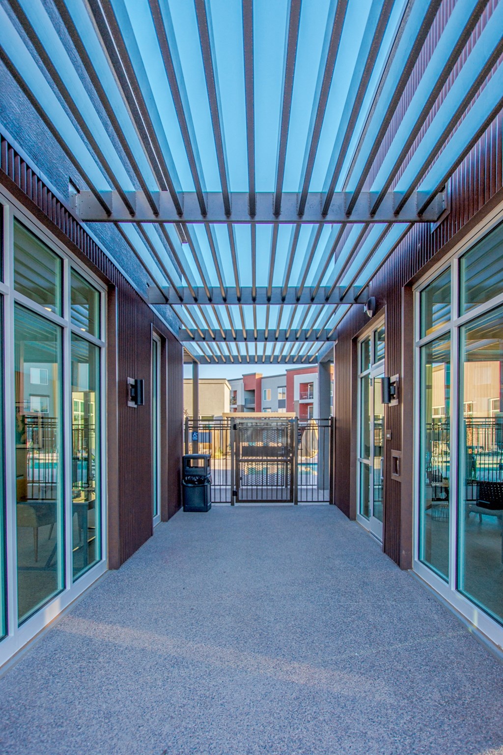 a large hallway with glass doors and a balcony