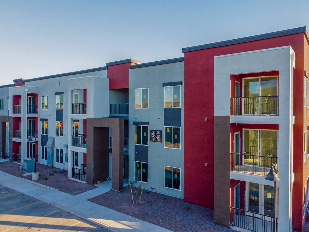a row of colorful apartment buildings in front of a blue sky