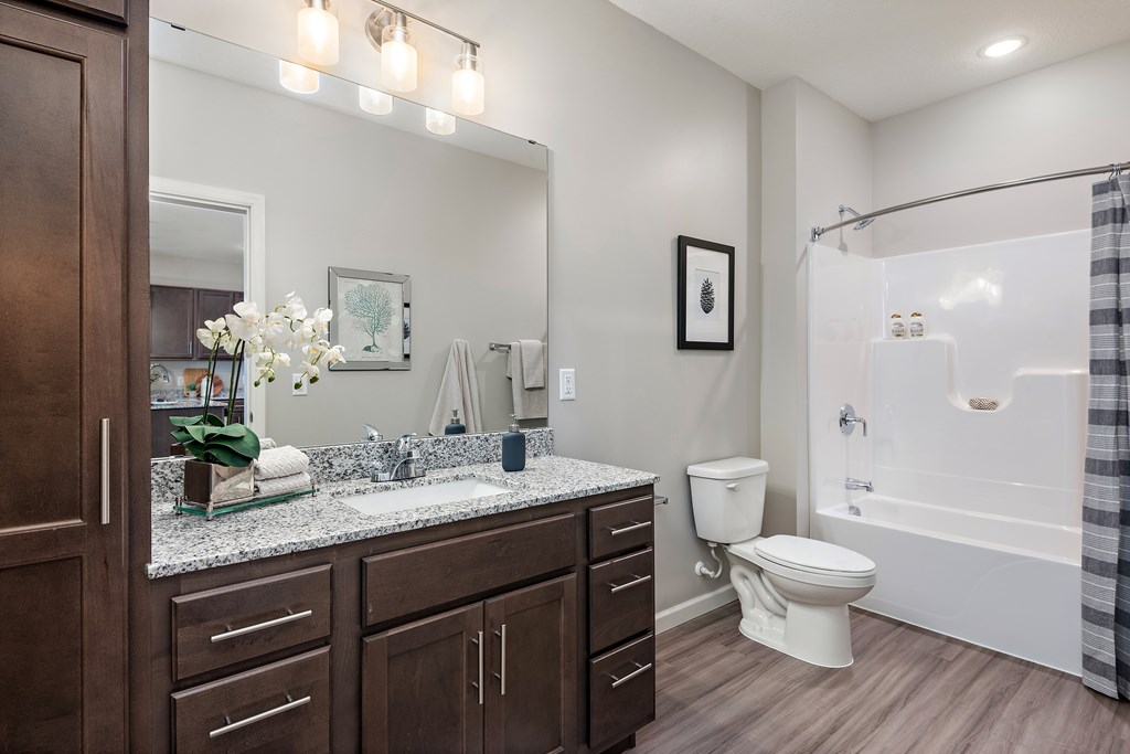 A bathroom with a white toilet and a white sink.