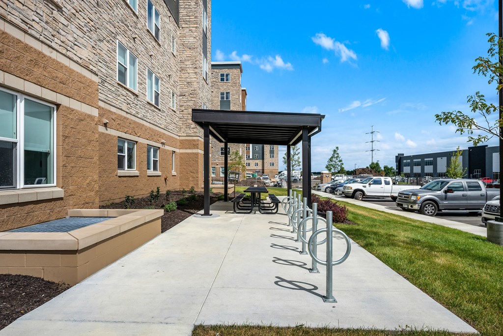 A row of bicycle racks are outside a building.