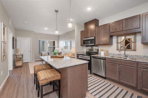 A kitchen with brown cabinets and a white island.