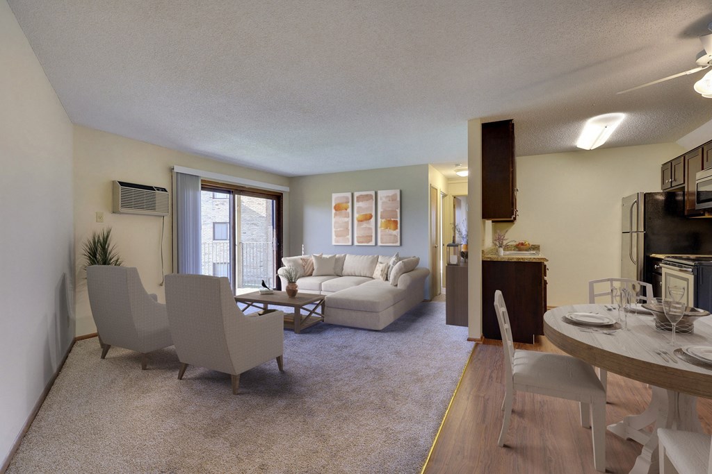 an open living room and dining room with a couch and chairs and a table and