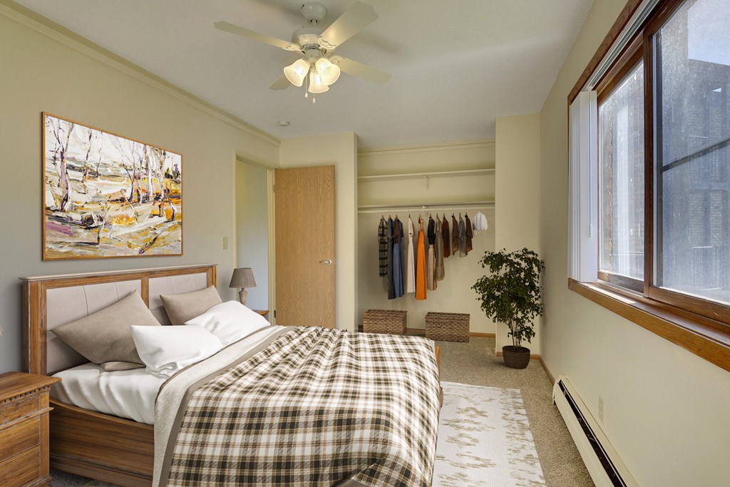 a bedroom with a bed and a ceiling fan