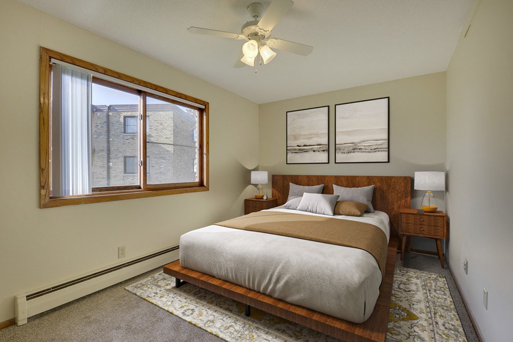 a bedroom with a large bed and a large window