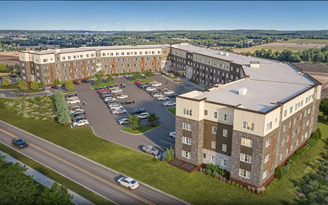 A large building with a parking lot in front of it.