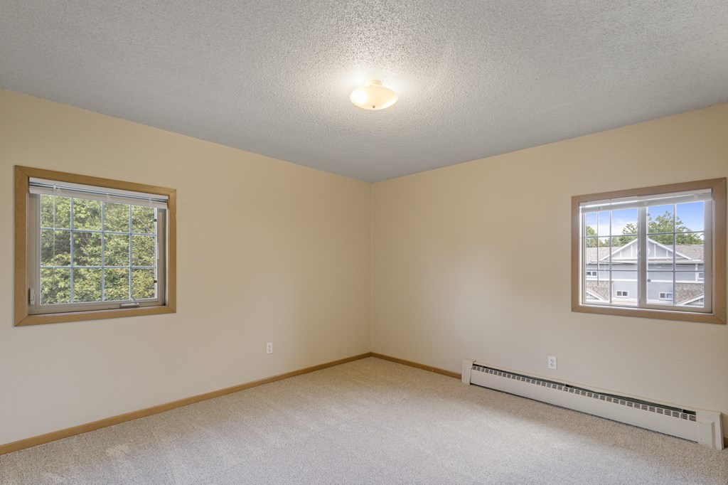 A room with a window and a wall-mounted air conditioner at Ames Lake Neighborhood Apartments, Minnesota