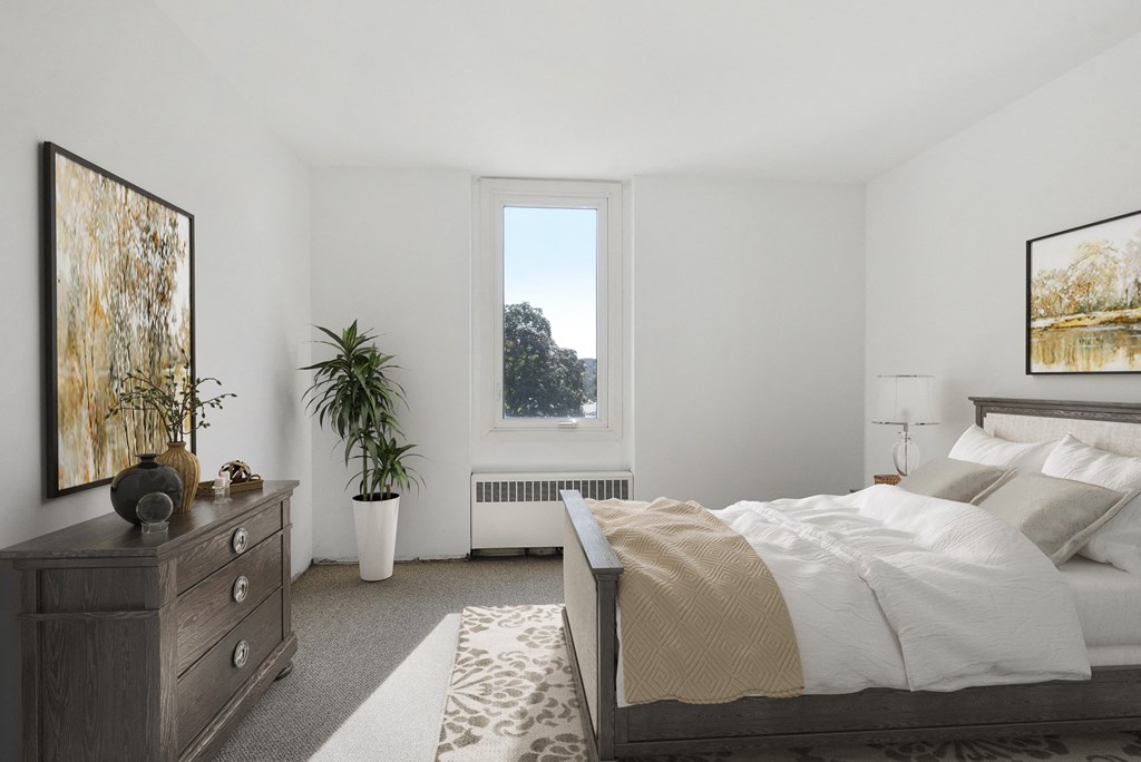 a bedroom with a bed and a dresser and a window at Humboldt Senior 55+ Apartments, Saint Paul, Minnesota