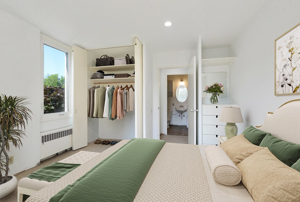 a bedroom with a bed and a closet at Humboldt Senior 55+ Apartments, Saint Paul, MN, 55107