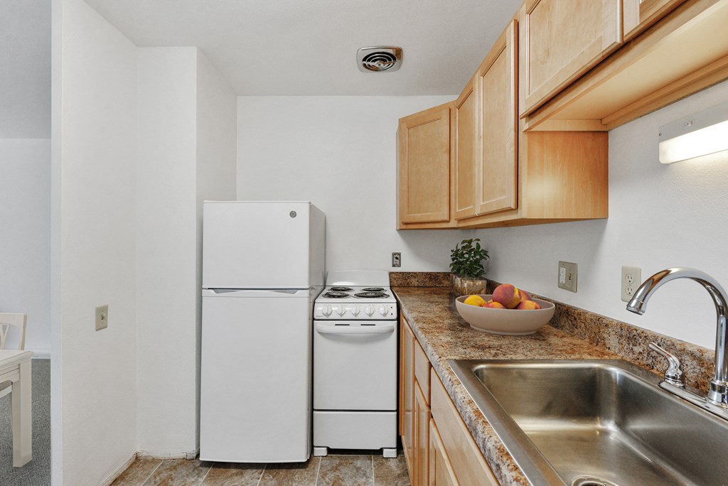 a kitchen with a sink and a refrigerator at Humboldt Senior 55+ Apartments, Saint Paul, 55107