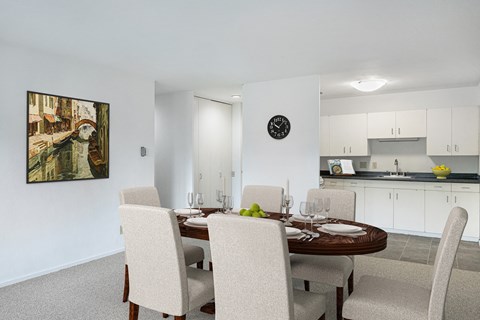 a dining room with a table and chairs and a kitchen