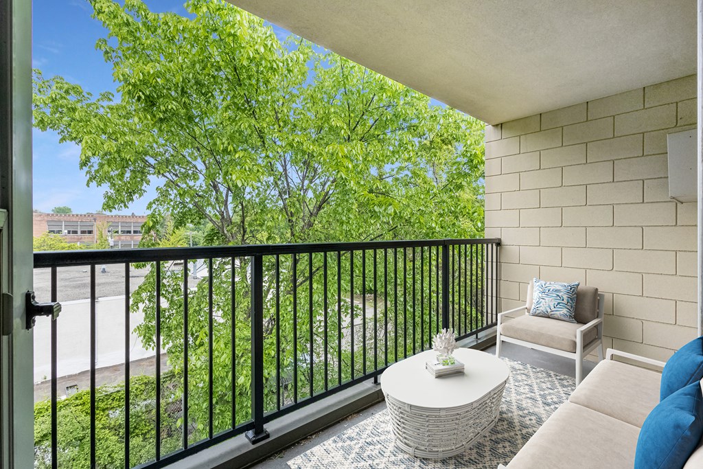a living room with a couch and a table on a balcony at Humboldt Senior 55+ Apartments, Minnesota, 55107