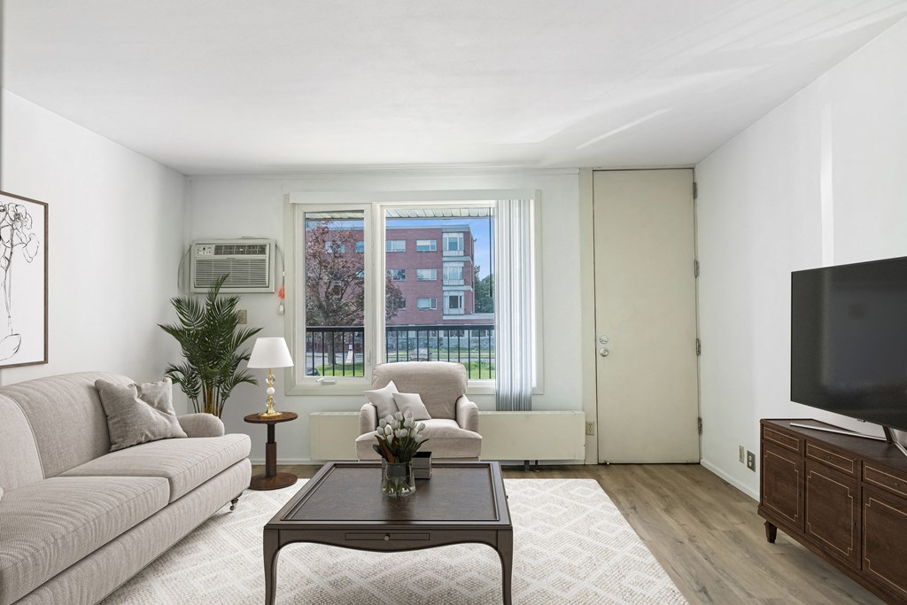 a living room with a couch and a coffee table at Humboldt Senior 55+ Apartments, Saint Paul