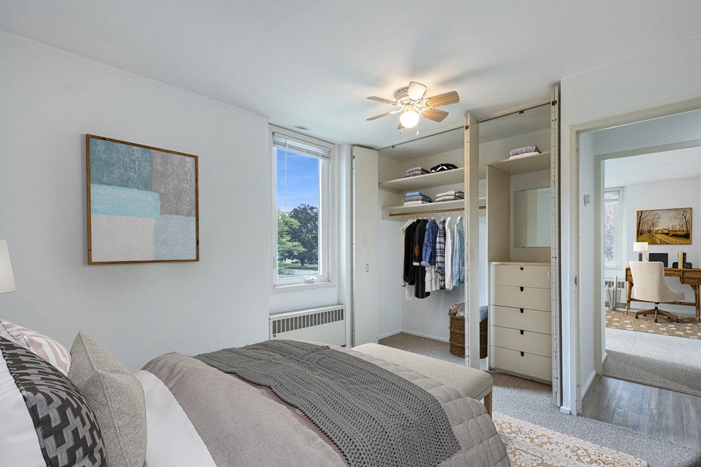 a bedroom with a bed and a closet at Humboldt Senior 55+ Apartments, Minnesota
