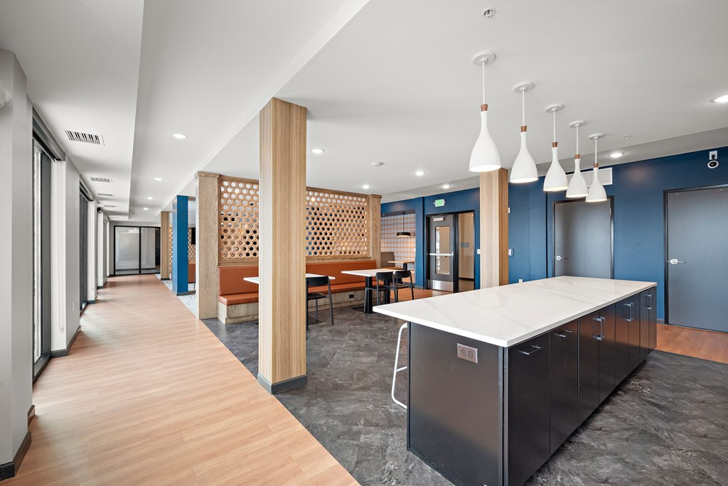 A long hallway with a kitchen area at the end. at The Landing at Amber Fields Apartments, Rosemount, MN
