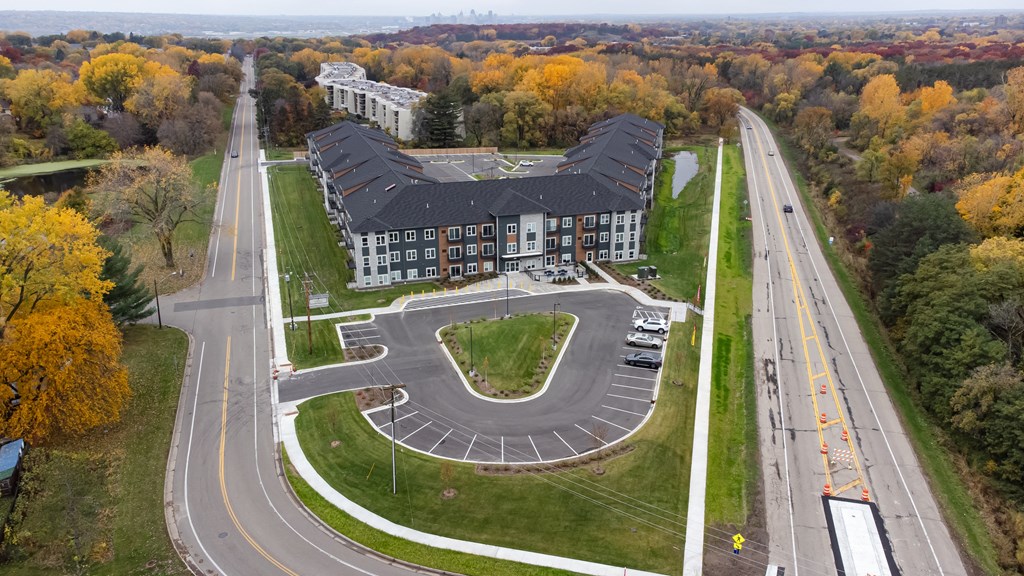 an aerial view of a large building with a road in front of it