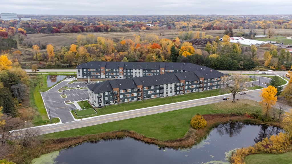 an aerial view of a Londin Crossing next to a pond