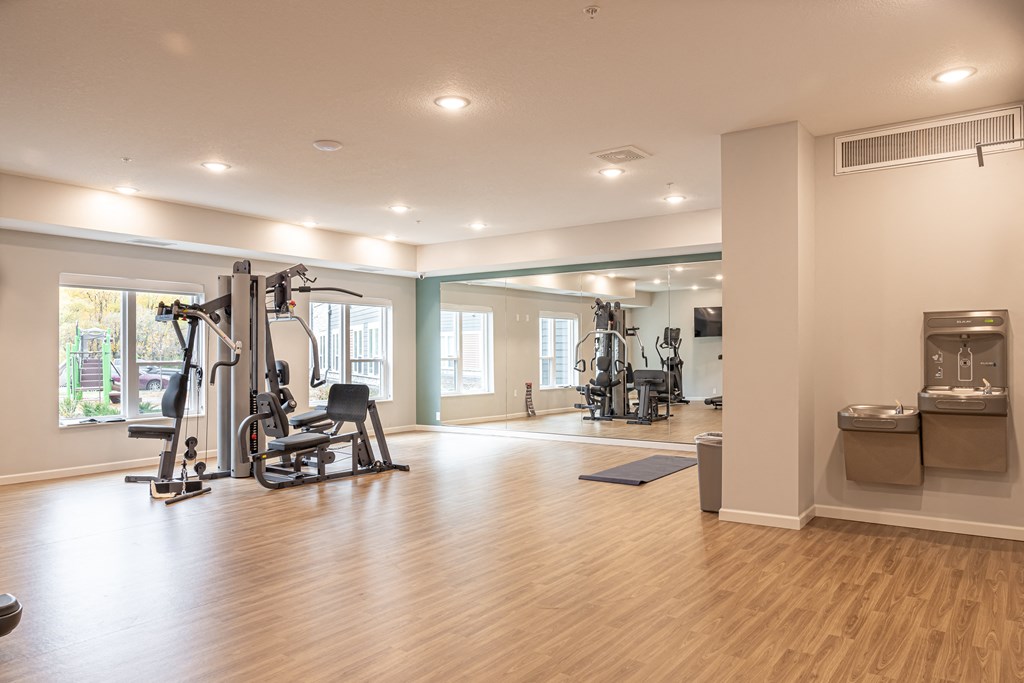 a gym with exercise equipment and a window