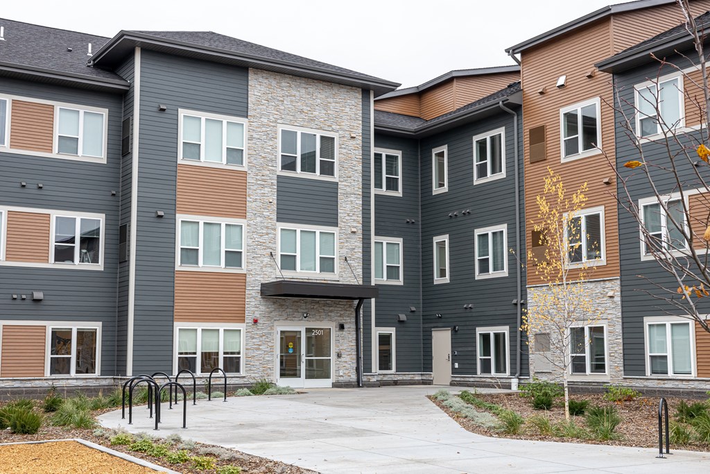a group of townhouses with a sidewalk in front of them