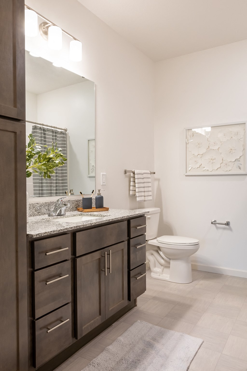 a bathroom with a sink and a toilet and a mirror
