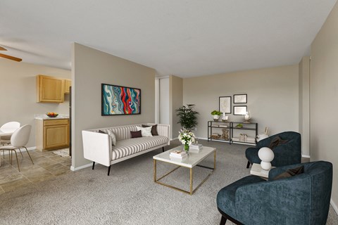 a living room with a couch and chairs and a table