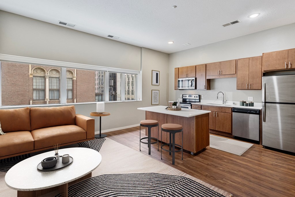 a living room with a kitchen and a couch