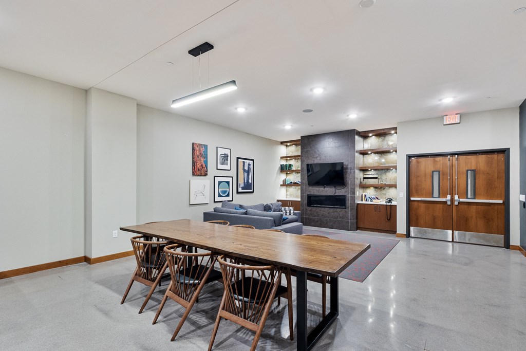 a large dining room with a wooden table and chairs