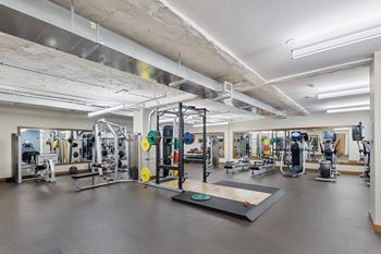 a gym with weights and other exercise equipment in a building