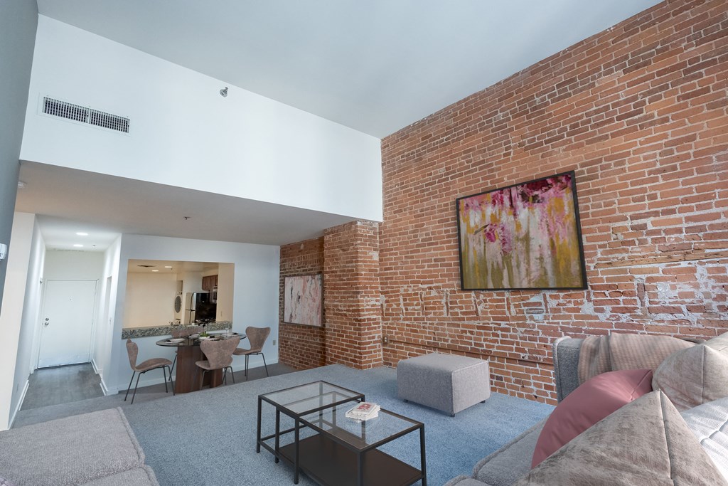 a living room with a brick wall and a couch and a coffee table