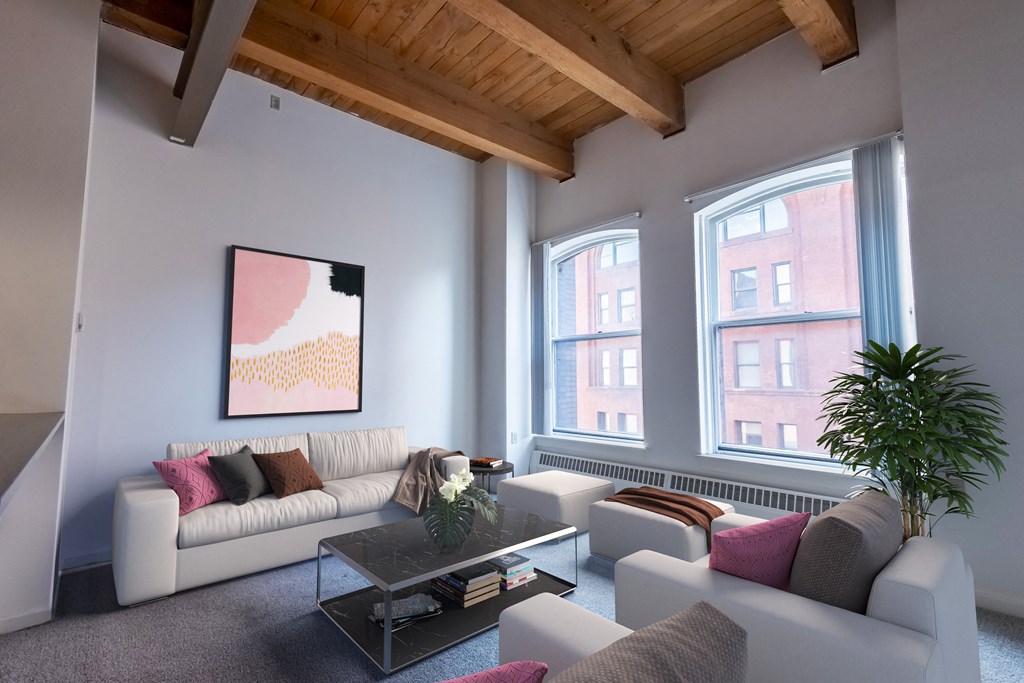 a living room with white couches and a coffee table