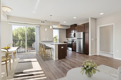 A modern kitchen with a dining table and chairs.